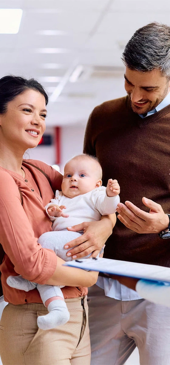 nurse talks to family with newborn