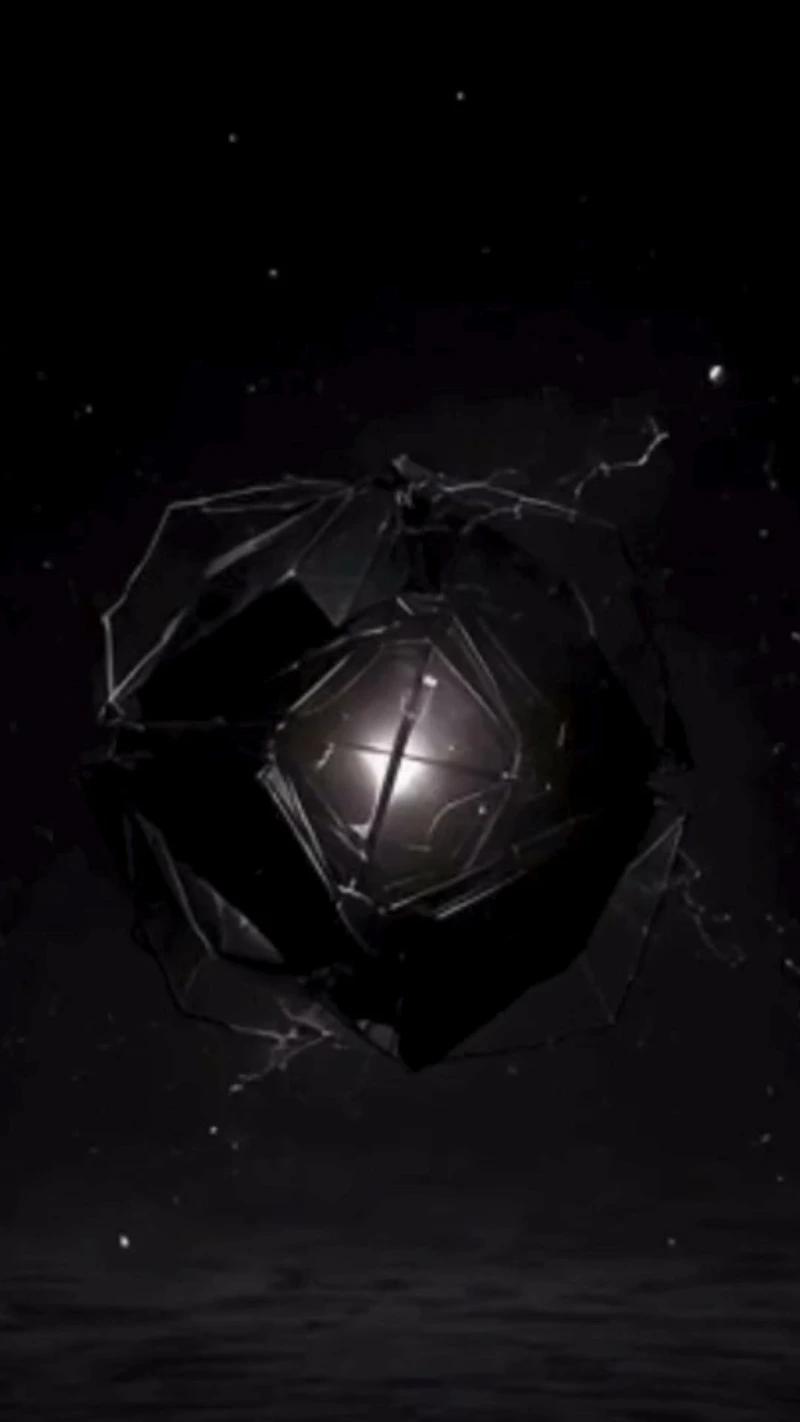 A dark faceted object with a lit core