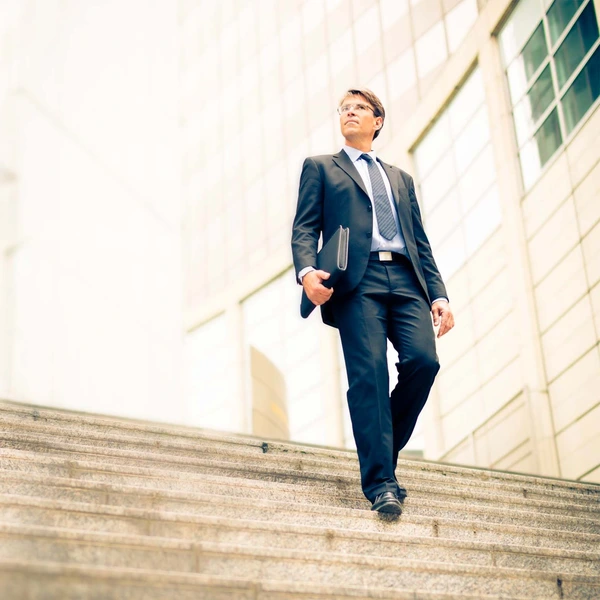 executive walking down steps