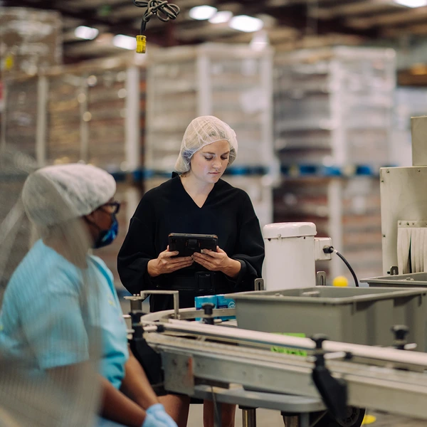 TelPak employees inspecting manufacturing
