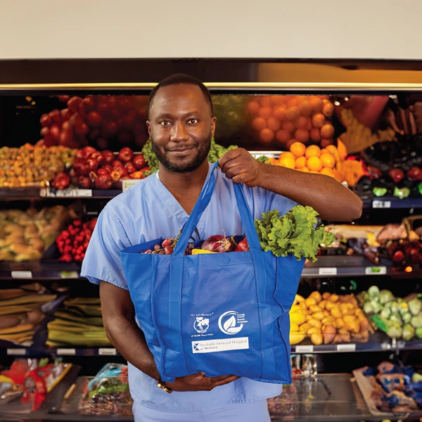 male nurse holding a food tote at NGH Food Pharmacy
