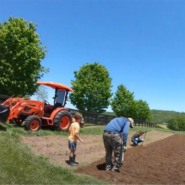 image of the family planting seeds