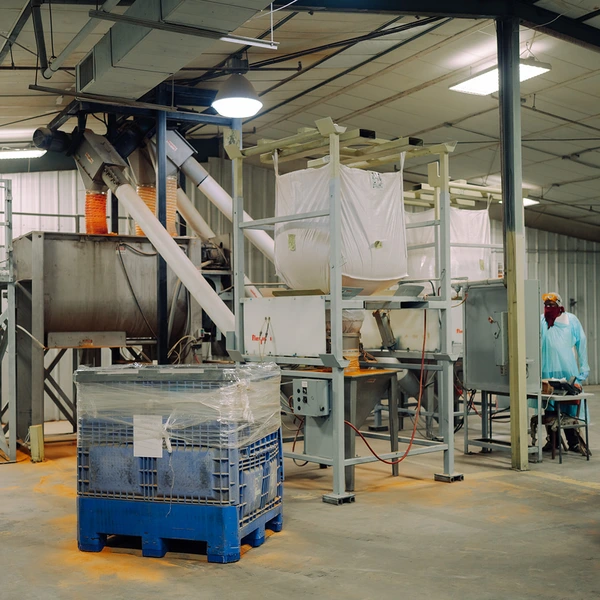Forklift moving bulk totes in the TEKPAK blending area